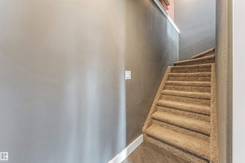 Staircase featuring plush carpeting and a neutral color palette - 5928 12 Avenue, Edmonton, AB 