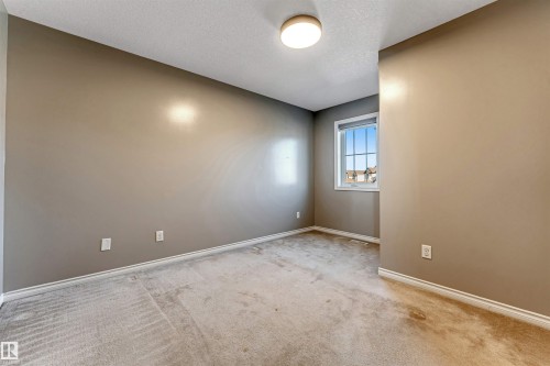 Neutral-toned walls complement plush carpet flooring - 5928 12 Avenue, Edmonton, AB 