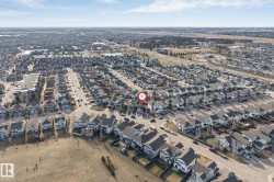 Aerial perspective showcasing a residential neighborhood with numerous single-family homes - 