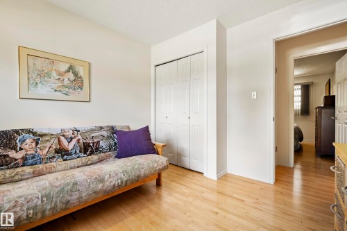 Light-toned wood-finish flooring provides a bright base for this room - 3208 70 Street, Edmonton, AB 