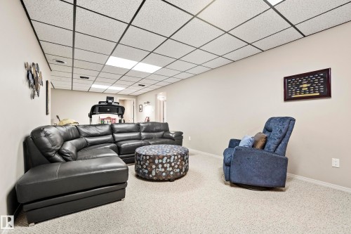 Carpeted room with a grid drop ceiling and recessed lighting - 3208 70 Street, Edmonton, AB 