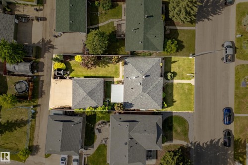 Aerial perspective showcasing the property's rectangular lot with a central residence and detached structure - 3208 70 Street, Edmonton, AB 