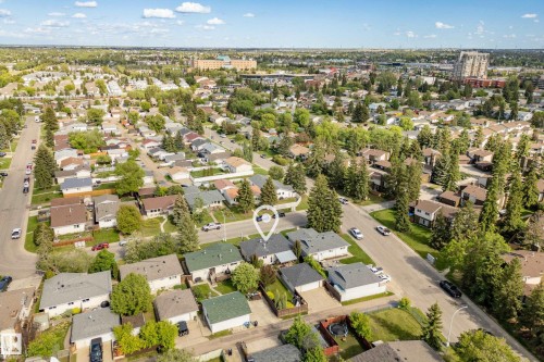 Aerial view showcasing an established residential area with mature trees and a mix of single-family homes - 3208 70 Street, Edmonton, AB 
