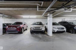 Secured underground parking with concrete flooring and overhead lighting - 