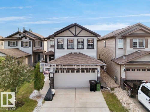 Modern two-story home featuring a two-car garage, partial stone facade, gable roofline, and contrasting trim details - 3756 8 Street, Edmonton, AB 