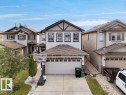 Modern two-story home featuring a two-car garage, partial stone facade, gable roofline, and contrasting trim details - 3756 8 Street, Edmonton, AB 