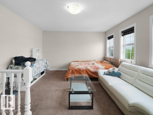 Carpeted room with neutral wall tones and white trim - 3756 8 Street, Edmonton, AB 