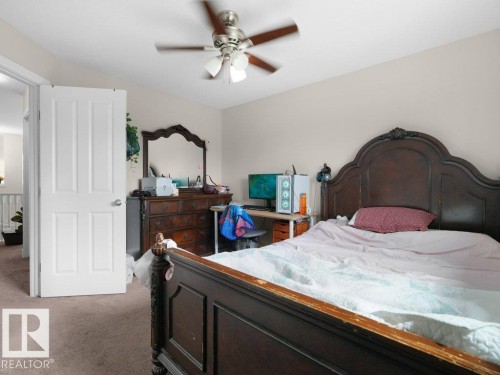 Bedroom featuring light-toned wall paint and an overhead ceiling fan with light fixture - 3756 8 Street, Edmonton, AB 