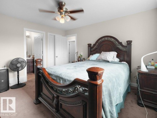 Bedroom with carpeting, neutral wall color, and a ceiling fan with integrated lighting - 3756 8 Street, Edmonton, AB 