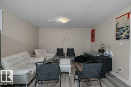 Spacious room featuring light-toned walls and wood-finish flooring - 3756 8 Street, Edmonton, AB 