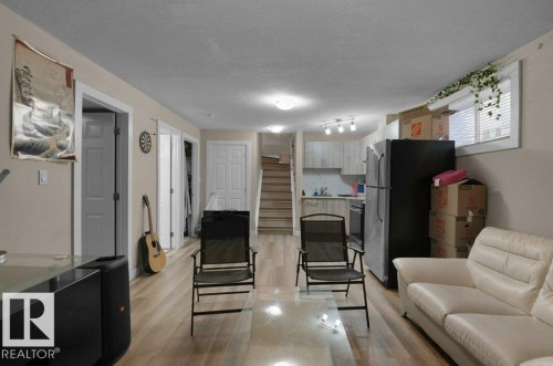 Open-concept living space featuring wood-finish flooring throughout - 3756 8 Street, Edmonton, AB 