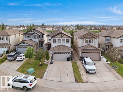 Two-story residence featuring a front entry with a covered porch, a double-car attached garage, and a concrete driveway - 3756 8 Street, Edmonton, AB 