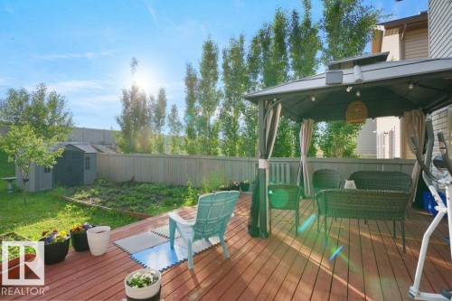 Expansive wood-finish deck with a built-in gazebo and string lighting - 3756 8 Street, Edmonton, AB 