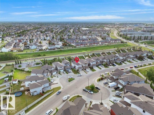Aerial overview of a residential neighborhood with detached homes and townhouses - 3756 8 Street, Edmonton, AB 
