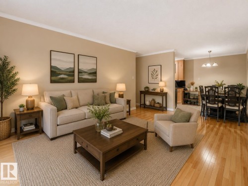 Living area featuring wood-finish flooring, crown molding, and neutral wall tones - 403 10165 113 Street, Edmonton, AB 