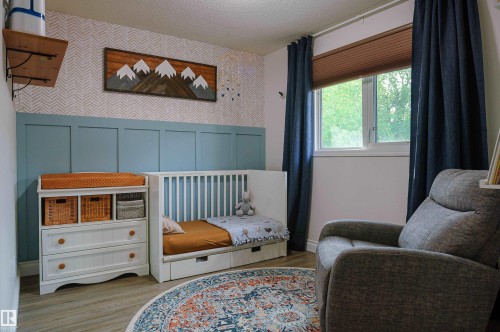 Wall-mounted shelving with decorative brackets, a single window with blinds and drapes, and wood-finish flooring - 58 Lodgepole Crescent, St. Albert, AB 