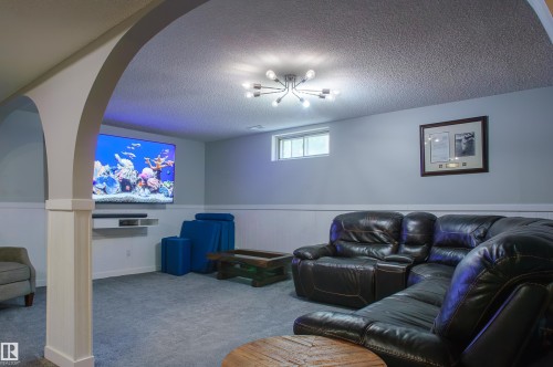 Spacious room featuring archway architecture and plush carpeting - 58 Lodgepole Crescent, St. Albert, AB 