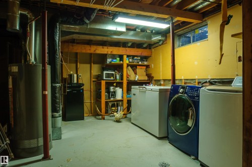 Utility room featuring a water heater, visible HVAC ductwork, and exposed ceiling joists - 58 Lodgepole Crescent, St. Albert, AB 
