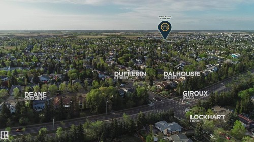Expansive aerial perspective showcasing a mature residential area with abundant tree cover - 58 Lodgepole Crescent, St. Albert, AB 