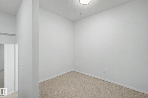 Neutral tone walls with light-colored carpet flooring - 11150 83 Avenue, Edmonton, AB 