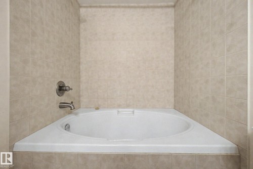 Corner soaking tub with a tiled surround - 11150 83 Avenue, Edmonton, AB 