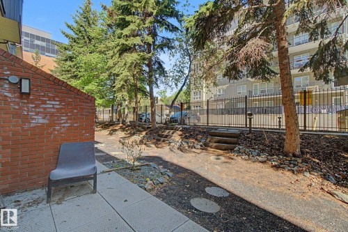 Brick exterior wall with an exterior light fixture - 11150 83 Avenue, Edmonton, AB 