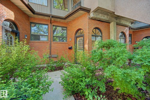 Brick exterior featuring arched entryways and multiple windows - 11150 83 Avenue, Edmonton, AB 