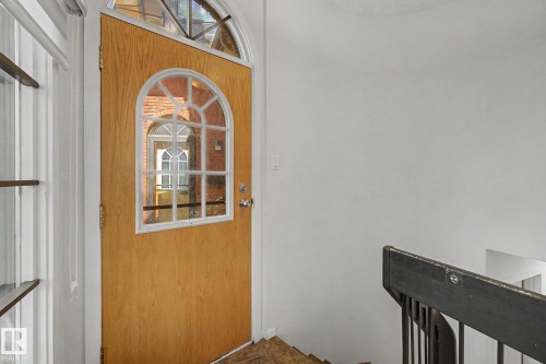 Arched entry door with a wood-finish and decorative glass inserts - 11150 83 Avenue, Edmonton, AB 