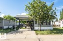 Exterior featuring light gray horizontal siding and a dark gray accent band - 233 Oak Wood Drive, Edmonton, AB 