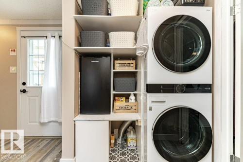 Dedicated laundry area featuring stacked front-load washer and dryer units - 233 Oak Wood Drive, Edmonton, AB 