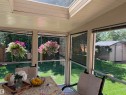 Sunroom featuring a skylight, expansive windows, a solid panel ceiling, and a view of the backyard with a utility shed - 15804 80 Street, Edmonton, AB 