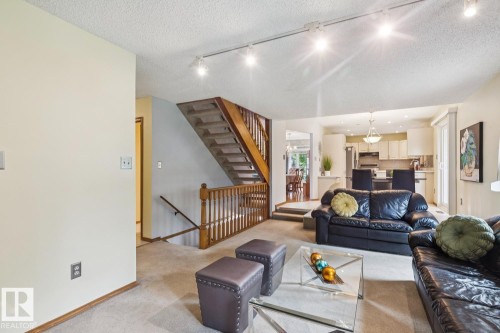 Living area featuring light-colored walls and track lighting - 15804 80 Street, Edmonton, AB 