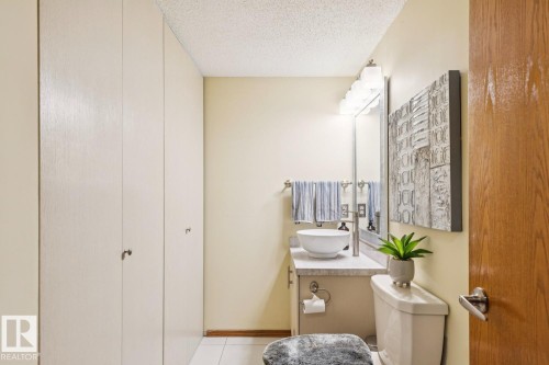 Bathroom featuring a vessel sink atop a vanity with a light-colored countertop - 15804 80 Street, Edmonton, AB 