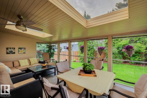Enclosed patio space featuring a slatted ceiling, skylight, and ceiling fan - 15804 80 Street, Edmonton, AB 