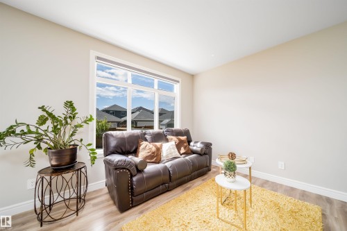 Spacious interior featuring light-toned walls and wood-finish flooring - 16123 31 Avenue, Edmonton, AB 