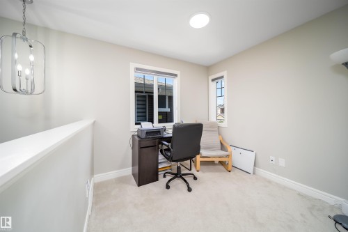 Recessed lighting, a chrome-finish chandelier, and two windows illuminate this flexible space - 16123 31 Avenue, Edmonton, AB 