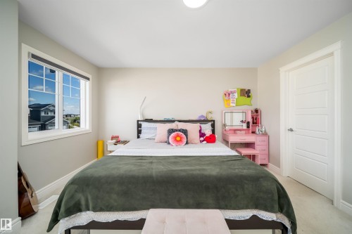 Bright room featuring a multi-pane window, light-toned walls, and wood-finish flooring - 16123 31 Avenue, Edmonton, AB 