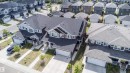 Contemporary-style residence featuring a dark grey exterior with light grey accents and a gabled roofline - 16123 31 Avenue, Edmonton, AB 