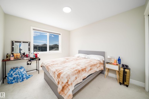 Bright interior with a large window, plush carpeting, recessed ceiling lighting, baseboard molding, and neutral wall tones - 16123 31 Avenue, Edmonton, AB 