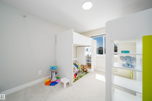 Bright room featuring light-colored walls and soft carpet flooring - 16123 31 Avenue, Edmonton, AB 
