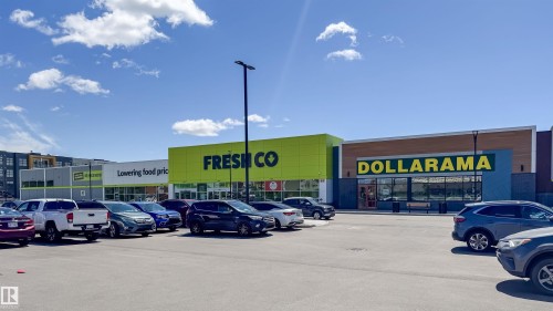 Retail storefronts featuring bright signage, multiple entrances, and a paved parking area - 16123 31 Avenue, Edmonton, AB 