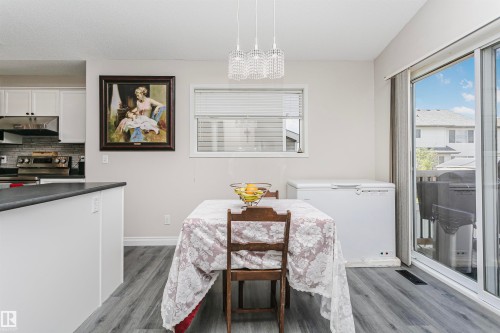 Kitchen and dining area featuring wood-finish flooring - 4228 162 Avenue, Edmonton, AB 