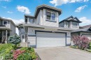 Light-toned siding exterior with dark trim accents - 4228 162 Avenue, Edmonton, AB 