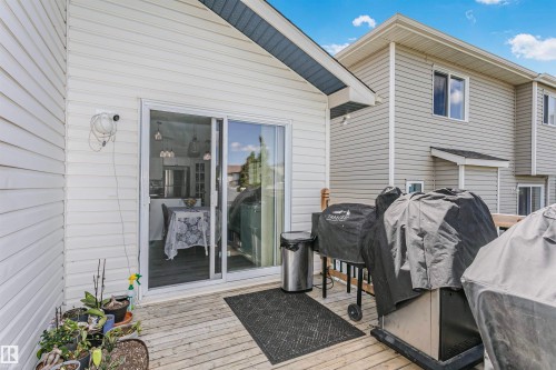Outdoor wood-finish deck with white siding exterior - 4228 162 Avenue, Edmonton, AB 