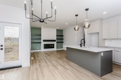 Open-concept living space with wood-finish flooring - 