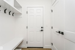 Mudroom with built-in bench seating and shelving - 
