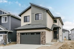 Contemporary two-story exterior with multi-toned siding and stone accents - 