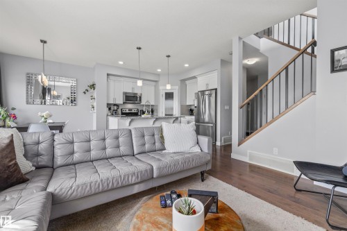 Open-concept living area with wood-finish flooring - 607 40 Street, Edmonton, AB 