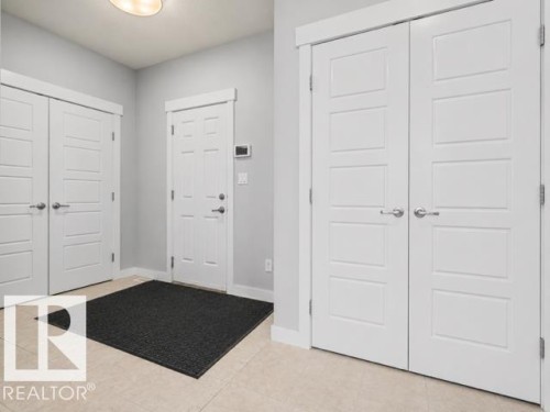 Entryway featuring light-toned tile flooring and pale gray wall finishes - 607 40 Street, Edmonton, AB 