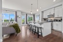 Open-concept living space with dark wood-finish flooring - 607 40 Street, Edmonton, AB 